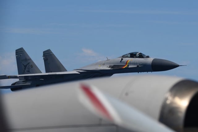 A Chinese J-15 fighter jet flies near a Japanese P-3C patrol aircraft over the Pacific Ocean on June 8, 2025.