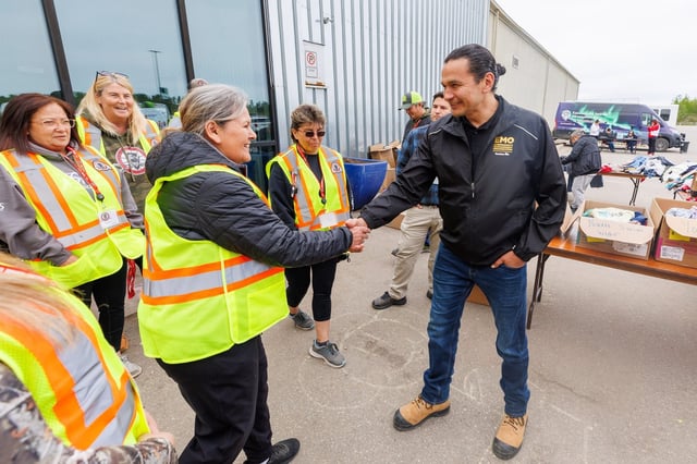 Manitoba Premier Wab Kinew meets with staff from the Manitoba Metis Federation outside the evacuation centre at the Thompson Regional Community Centre in Thompson, Man.  during a tour of wildfires in northern Manitoba on Thursday, June 12, 2025. THE CANADIAN PRESS/Mike Deal-Pool