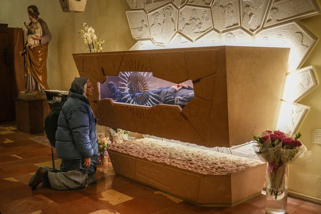 ASSISI, ITALY - MARCH 18: (EDITORS NOTE: This image depicts death.) A nun prays at the tomb of Blessed Carlo Acutis in the Church of Santa Maria Maggiore on March 18, 2025 in Assisi, Italy. Assisi is the resting place of Carlo Acutis, a London-born Italian teenager who died from leukemia in 2006 and was later beatified by Pope Francis in 2020. Acutis, who has been referred to as "God's Influencer," will become the first millennial saint when he is canonised in a ceremony next month during the Church's Jubilee of Teenagers.  It was Carlos Acutis's final wish to be buried in Assisi. On 6th April 2019, his body was brought to the Sanctuary of the Spoliation and will be his final resting, attracting pilgrims from across the world to visit his tomb and that of St. Francis of Assisi in the nearby Basilica of St. Francis of Assisi. (Photo by Christopher Furlong/Getty Images)