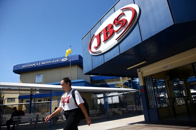 A woman walks in front of the JBS meat factory, in Montenegro, Rio Grande do Sul, Brazil, December 5, 2024. REUTERS/Diego Vara/File Photo
