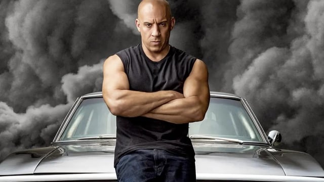 Dom Toretto in front of his 1970 Dodge Charger.
