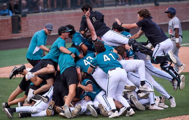 Coastal Carolina players dogpile after winning the Auburn Super Regional to advance to the 2025 College World Series.