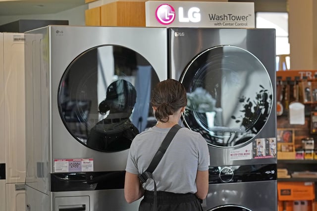 A customer looks at LG washing machines and dryers.