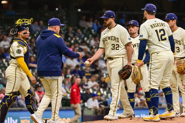 Jun 9, 2025; Milwaukee, Wisconsin, USA; Milwaukee Brewers starting pitcher Aaron Civale (32) hands the ball to manager Pat Murphy during a pitching change in the fifth inning against the Atlanta Braves at American Family Field. Mandatory Credit: Benny Sieu-Imagn Images/File Photo