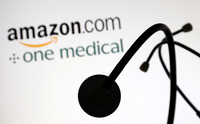 A stethoscope is placed on displayed Amazon.com and One Medical logos in this illustration taken July 26, 2022. REUTERS/Dado Ruvic/Illustration