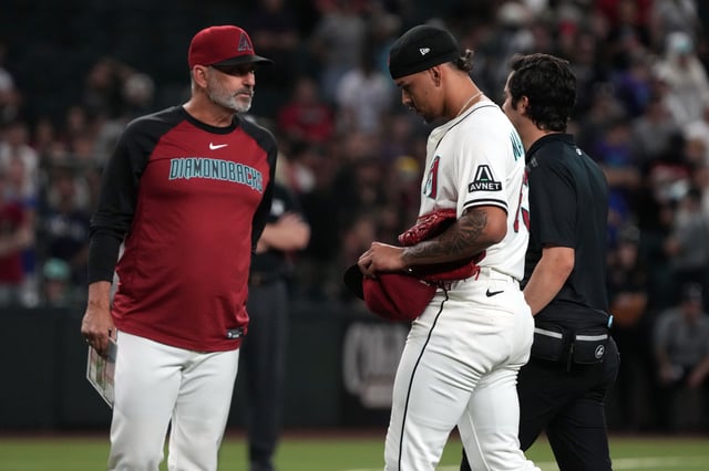 Jun 9, 2025; Phoenix, Arizona, USA; Arizona Diamondbacks pitcher Justin Martinez (63) leaves the game after an injury against the Seattle Mariners in the ninth inning at Chase Field. Mandatory Credit: Rick Scuteri-Imagn Images/File Photo