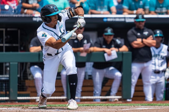 Jun 13, 2025; Omaha, Neb, USA; Coastal Carolina Chanticleers left fielder Sebastian Alexander (1) hits a sacrifice bunt against the Arizona Wildcats during the first inning at Charles Schwab Field. Mandatory Credit: Dylan Widger-Imagn Images