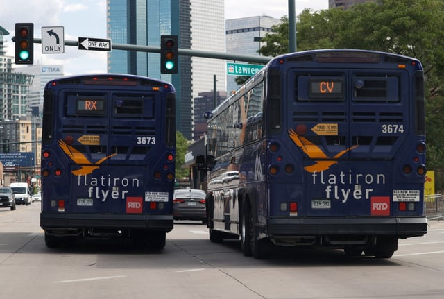 Flatiron Flyer buses hustle down Broadway to pick up fares bound for Boulder on July 23, 2020, in downtown Denver.