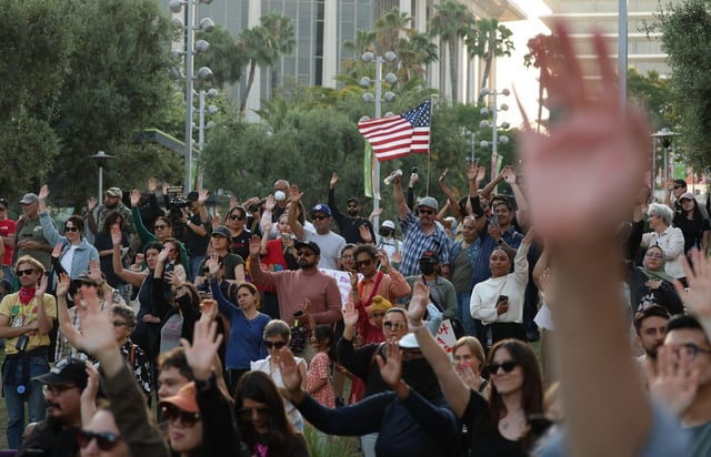 Demonstrators join a prayer vigil in Grand Park, Downtown LA, as protests continue in response to federal immigration operations in Los Angeles on June 10, 2025. Hundreds of Marines are due to arrive in Los Angeles on June 10 after US President Donald Trump ordered their deployment in response to protests against immigration arrests and despite objections by state officials. The 700 troops will join National Guard soldiers, amping up the militarization of the tense situation in the sprawling city, which is home to millions of foreign-born and Latino residents. The unrest was sparked by a sudden intensification of Trump’s signature campaign to deport illegal migrants, with raids conducted on workplaces. (Photo by Patrick T. Fallon / AFP) (Photo by PATRICK T. FALLON/AFP via Getty Images)