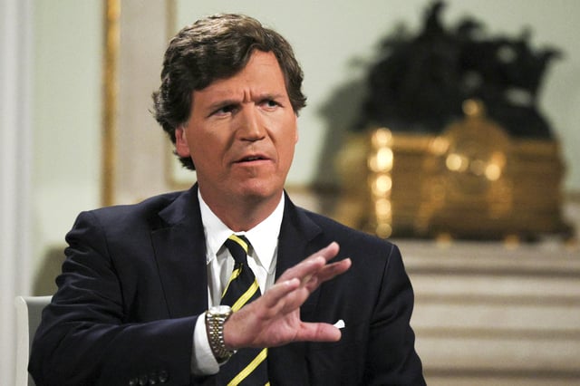 In this photo released by Sputnik news agency on Friday, Feb. 9, 2024, former Fox News host Tucker Carlson gestures during an interview with Russian President Vladimir Putin, at the Kremlin in Moscow, Russia, Tuesday, Feb. 6, 2024.