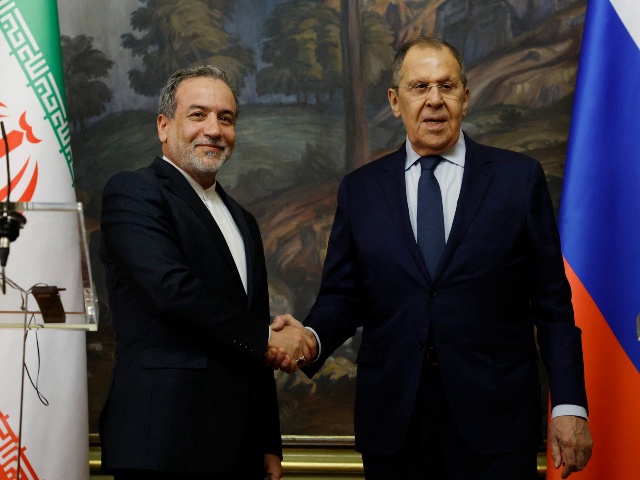 Russia's Foreign Minister Sergei Lavrov (R) shakes hands with Iran's Foreign Minister Abbas Araghchi (L) during a joint press conference following their talks in Moscow on April 18, 2025. (Photo by Tatyana MAKEYEVA / POOL / AFP)