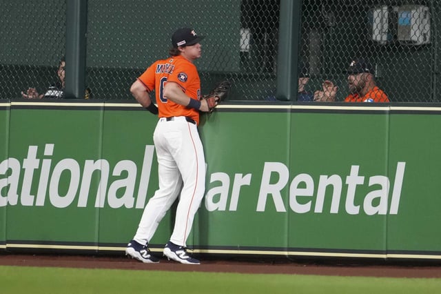 Houston Astros center fielder Jake Meyers (6) runs into the center field fence after chasing down a fly ball by Minnesota Twins Royce Lewis in the fourth inning of an MLB baseball game in Houston, Friday, June 13, 2025.