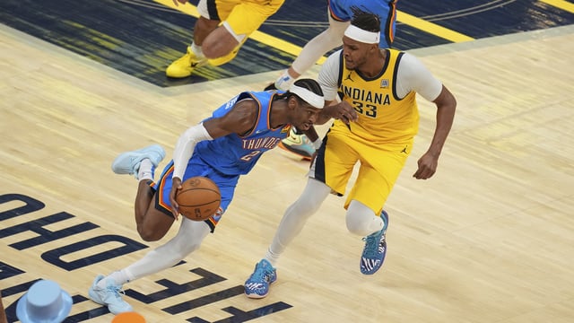 Oklahoma City Thunder guard Shai Gilgeous-Alexander (2) drives past Indiana Pacers center Myles Turner (33) during the second half of Game 4 of the NBA Finals basketball series, Friday, June 13, 2025, in Indianapolis. (AP Photo/Michael Conroy)