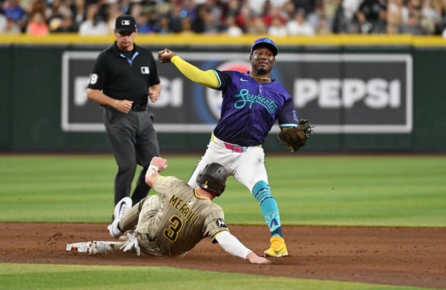 PHOENIX, ARIZONA – JUNE 13: Geraldo Perdomo #2 of the Arizona Diamondbacks turns a double play on a ground ball hit by Gavin Sheets #30 of the San Diego Padres as Jackson Merrill #3 is forced out at second base during the sixth inning at Chase Field on June 13, 2025 in Phoenix, Arizona. (Photo by Norm Hall/Getty Images)
