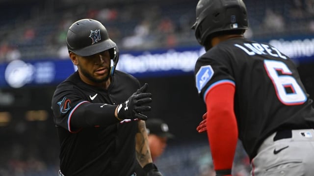 Jun 13, 2025; Washington, District of Columbia, USA; Miami Marlins designated hitter Agustin Ramirez (50) is congratulated by second baseman Otto Lopez (6) after hitting a solo home run against the Washington Nationals during the first inning at Nationals Park. Mandatory Credit: Brad Mills-Imagn Images