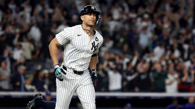 Oct 30, 2024; New York, New York, USA; New York Yankees designated hitter Giancarlo Stanton (27) reacts after hitting a home run during the third inning against the Los Angeles Dodgers in game five of the 2024 MLB World Series at Yankee Stadium. Mandatory Credit: Vincent Carchietta-Imagn Images