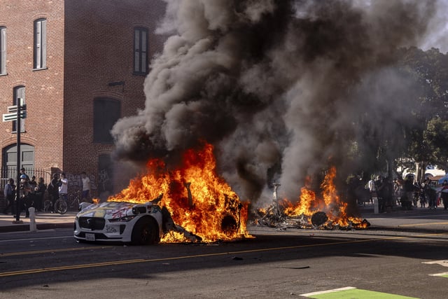 Two Waymo self-driving cars burn in flames during anti-ICE demonstrations in Los Angeles, on Sunday, June 8.         