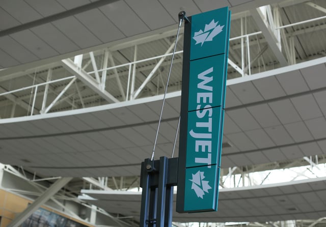 WestJet airline signage is pictured at Vancouver's international airport in Richmond, British Columbia, Canada, February 5, 2019.  REUTERS/Ben Nelms/File Photo