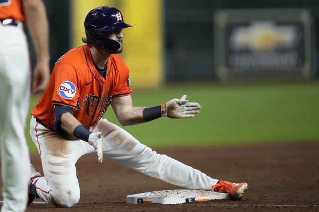 Houston Astros' Jacob Melton celebrates after hitting a two-run triple during the third inning of a baseball game against the Minnesota Twins, Friday, June 13, 2025, in Houston. (AP Photo/Kevin M. Cox)