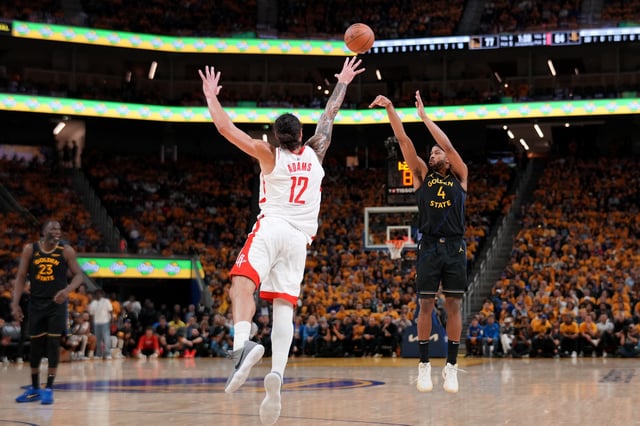 May 2, 2025; San Francisco, California, USA; Golden State Warriors guard Moses Moody (4) makes a three-point shot over Houston Rockets center Steven Adams (12) in the third quarter of game six of the first round for the 2025 NBA Playoffs at Chase Center. Mandatory Credit: Cary Edmondson-Imagn Images