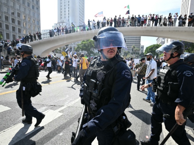 Sheriff's deputies and police clear an intersection near the Federal Building after declaring an unlawful assembly during the "No Kings" protest against the Trump administration in Los Angeles on June 14, 2025 on the day of Trump's military parade in Washington, DC. Tens of thousands of protesters rallied nationwide Saturday against Donald Trump ahead of a huge military parade on the US president's 79th birthday -- as the killing of a Democratic lawmaker underscored the deep divisions in American politics. "No Kings" demonstrators took to the streets in New York, Los Angeles, Chicago, Philadelphia, Houston, Atlanta and hundreds of other cities across the United States to condemn what they call Trump's dictatorial overreach. (Photo by Robyn BECK / AFP) (Photo by ROBYN BECK/AFP via Getty Images)