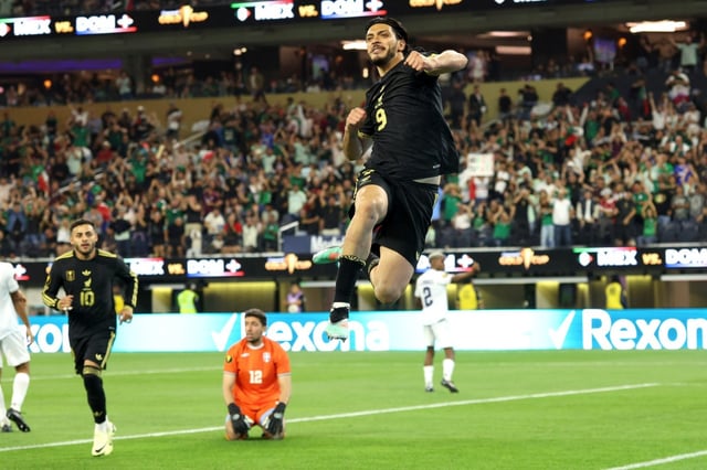 Mexico forward Raúl Jiménez, top, jumps in the air after scoring a goal past Dominican Republic goalkeeper Xavier Valdez (12) during the second half of a CONCACAF Gold Cup soccer match at SoFi Stadium in Inglewood, Calif. on Saturday, June 14, 2025.  Mexico won 3-2.  (Photo by Raul Romero Jr., Contributing Photographer)