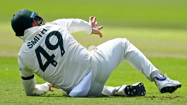 Australia's Steve Smith reacts after sustaining an injury.