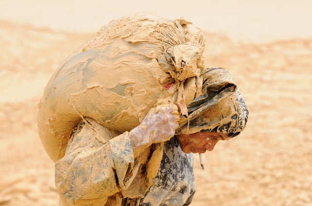 A man works at the site of a rare earth metals mine at Nancheng county, Jiangxi province, China, October 20, 2010. To match Insight ELECTRIC-CAR/COMMODITIES    REUTERS/Stringer/File Photo   CHINA OUT. NO COMMERCIAL OR EDITORIAL SALES IN CHINA/File Photo