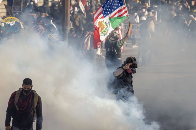 Police launch tear gas and shoot "less-than-lethal" munitions at people during a "No Kings" movement protest in the one-square mile area where daily protests have been occurring in response to a series of federal immigration raids on June 14, 2025, in Los Angeles, California.