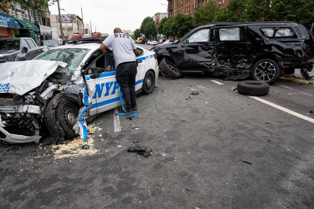 A man was arrested after crashing his black Chevrolet Suburban into a Volvo SUV before smashing into a NYPD cruiser on Avenue U in Brooklyn on Sunday June 15, 2025. (Theodore Parisienne / New York Daily News)