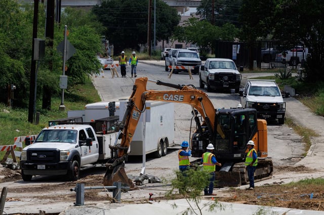 San Antonio Water System crews assess the damage along Vicar Drive at Beitel Creek in San Antonio on Friday, as flood recovery efforts continue in the area. Severe flash flooding brought on by record-setting rainfall early Thursday, resulted in 13 confirmed deaths.