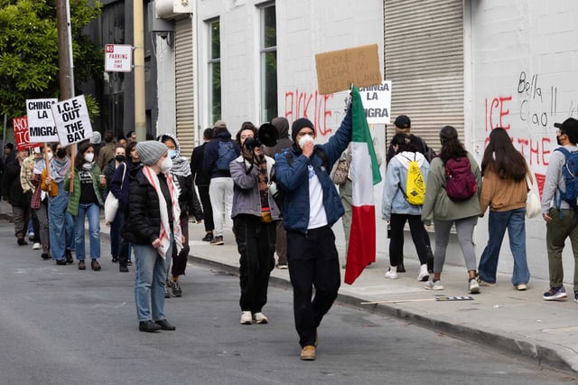Demonstrators protest Sunday outside 478 Tehama St. in San Francisco against Immigration and Customs Enforcement actions. Several immigrants received text messages ordering them to check in with ICE over the weekend, but the office remained closed during the protests. 