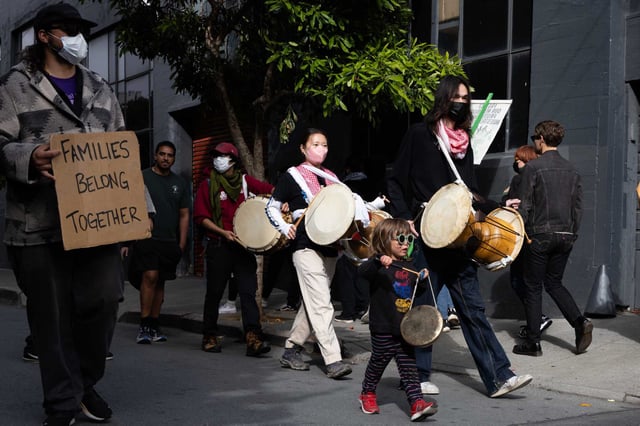 A crowd protests ICE actions outside a building in San Francisco’s South of Market early Sunday.