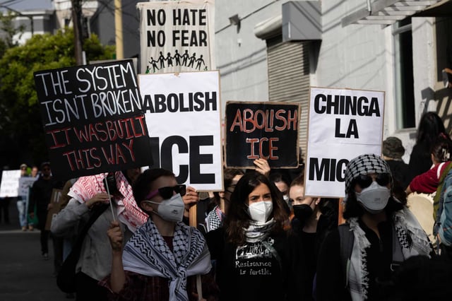 Demonstrators protest early Sunday outside 478 Tehama St. in San Francisco against Immigration and Customs Enforcement actions. Several immigrants received text messages ordering them to check in with ICE over the weekend, but the office remained closed during the protests. 