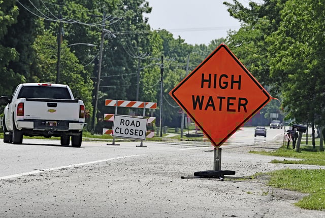 A sign warning of high water and road closure as a result of flash flooding in Kansas on June 4, 2025.