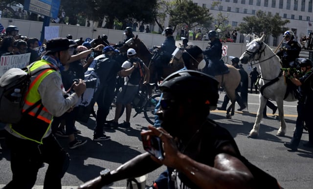 Protesters face off with LAPD on horseback as they push them back from the Edward R. Roybal Federal Building during the ‘No Kings’ protests Day in Los Angeles on Saturday, June 14, 2025. (Photo by Keith Birmingham, Orange County Register/ SCNG)