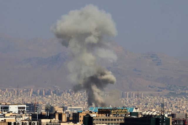 Smoke billows following an explosion in central Tehran on Sunday.