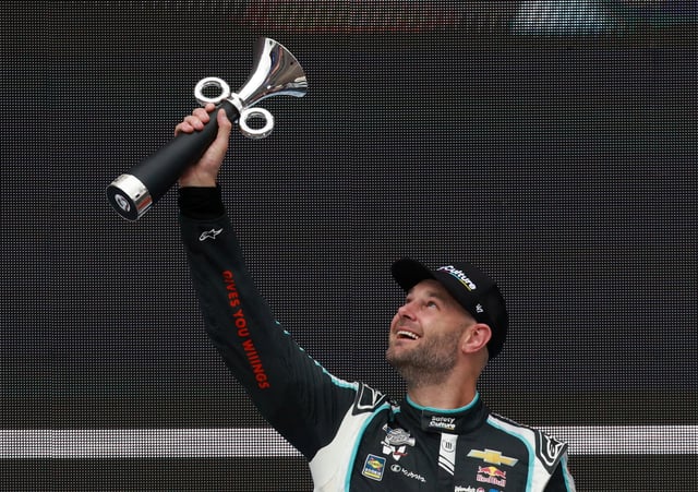 NASCAR - NASCAR Cup Series Mexico - Autodromo Hermanos Rodriguez, Mexico City, Mexico - June 15, 2025 Trackhouse Racing's Shane Van Gisbergen celebrates with a trophy on the podium after winning the NASCAR Cup Series Mexico REUTERS/Henry Romero