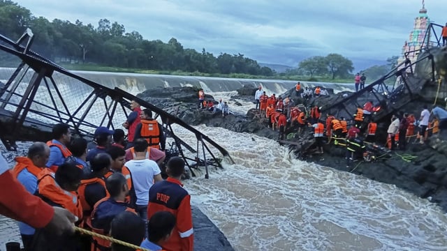 Rescuers work at the site of a bridge collapse near Pune on Sunday.