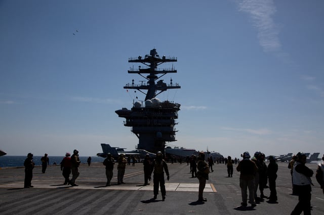 Crews are seen on the flight deck of the USS Nimitz, off the coast of Busan, South Korea, 27 March 2023/Pool via REUTERS/File Photo