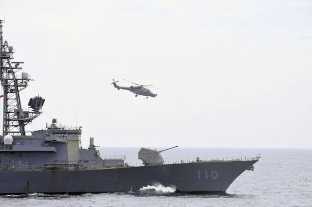 A Philippine naval helicopter hovers above the Japanese destroyer JS Takanami during a joint maritime exercise held off the coast of the Philippines&#39; main island of Luzon in the South China Sea on June 14, 2025.