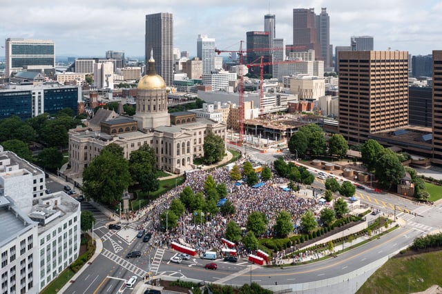 People taking part in a "No Kings" protest fill Liberty Plaza across from the Georgia State Capitol in Atlanta on Saturday.
