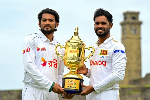 Sri Lanka's captain Dhananjaya de Silva (R) and his Bangladesh counterpart Najmul Hossain Shanto pose with the trophy on the eve of their first Test at Galle
