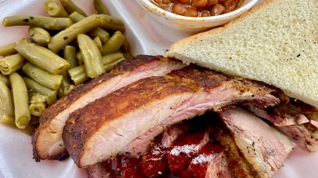 A combo plate from Off The Bone BBQ in Forest Hill with ribs, sausage and brisket.
