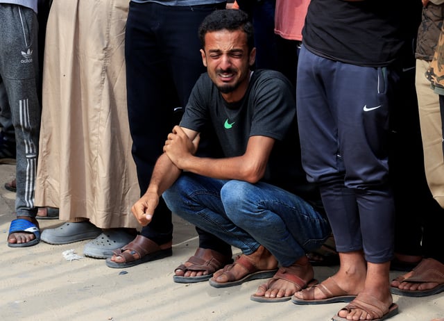 A mourner reacts during the funeral of Palestinians killed in what the Gaza health ministry says was Israeli fire near a distribution center in Rafah, at Nasser Hospital in Khan Younis, in the southern Gaza Strip, June 16, 2025. REUTERS/Hatem Khaled