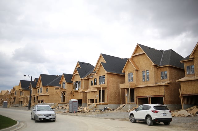 A row of houses under construction are seen at a subdivision near the town of Kleinburg, Ontario, Canada May 13, 2017. REUTERS/Chris Helgren/ File Photo