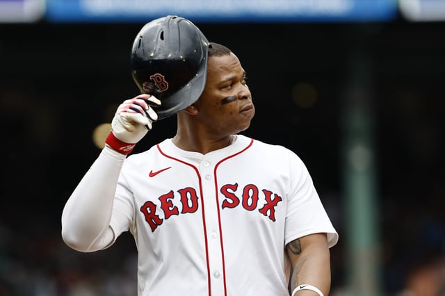 BOSTON, MA - MAY 4: Rafael Devers #11 of the Boston Red Sox heads for the dugout after flying out against the Minnesota Twins during the second inning at Fenway Park on May 4, 2025 in Boston, Massachusetts.