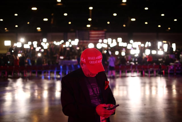 A supporter uses his mobile phone ahead of Republican presidential nominee and former U.S. President Donald Trump's watch party in Palm Beach County Convention Center, in West Palm Beach, Florida, U.S., November 5, 2024. REUTERS/Carlos Barria/ File Photo