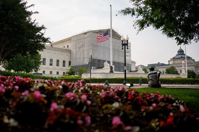 A person rests in front of the US Supreme Court on June 5, 2025 in Washington, DC.