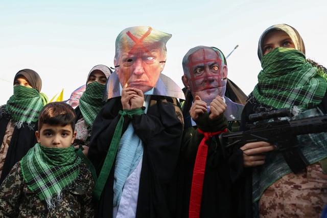 Members of Iranian paramilitary women forces (Basij) wear masks of Israel&#39;s Prime Minister Benjamin Netanyahu and US elect Donald Trump with a red cross of it, during an anti-Israeli rally to show their solidarity with the Palestinian and Lebanese people, in Tehran, January 10, 2025.